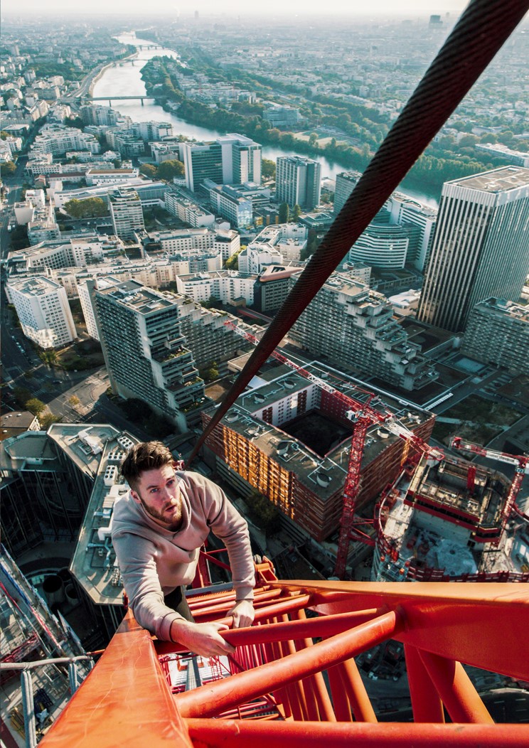 A photo of YouTube content creator and social media star James Kingston climbing a crane. He is one of the creators represented by Zoomin MCN.
